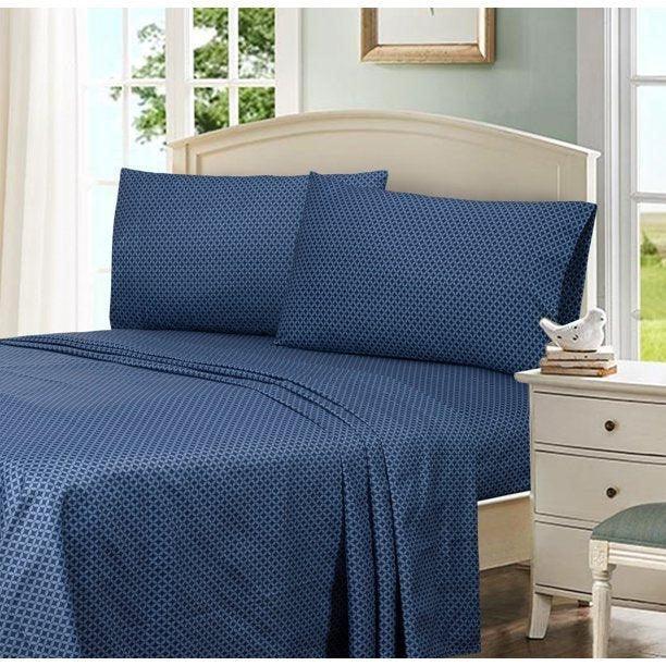 Navy blue Egyptian cotton bed sheets with geometric dot pattern, styled on a bed with matching pillows near a window