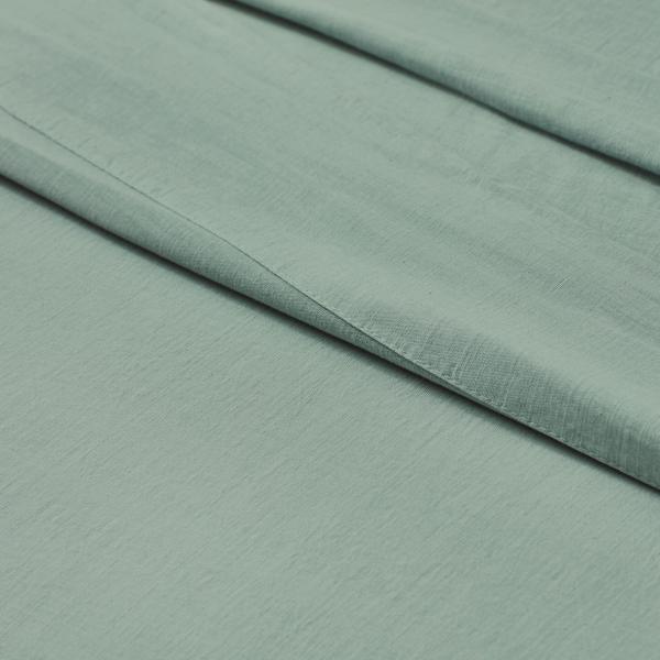 Soft sage green Egyptian cotton bed sheet with fine texture and elegant drape
