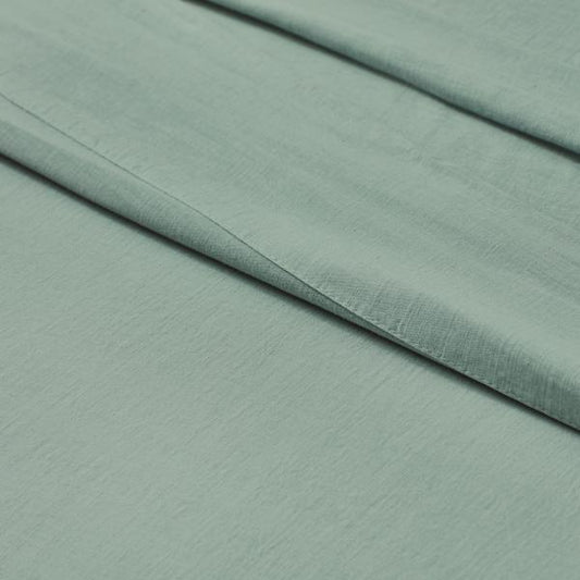 Soft sage green Egyptian cotton bed sheet with fine texture and elegant drape