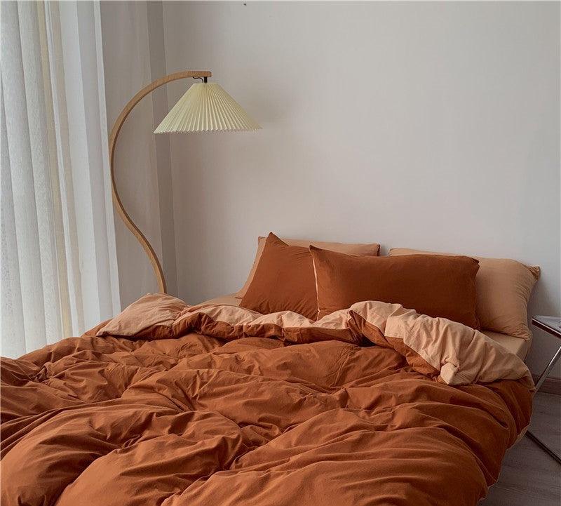 Luxury rust-colored Egyptian cotton bedding set with cozy duvet and pillows in a modern bedroom