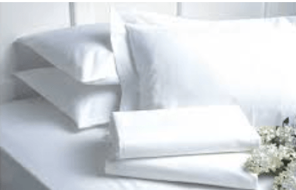 Luxury white Egyptian cotton bed sheets and pillows for cozy bedding setup
