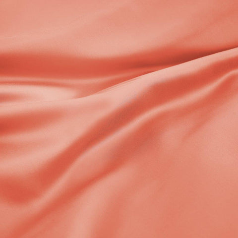 Soft coral Egyptian cotton bed sheet with smooth, luxurious texture and elegant drape