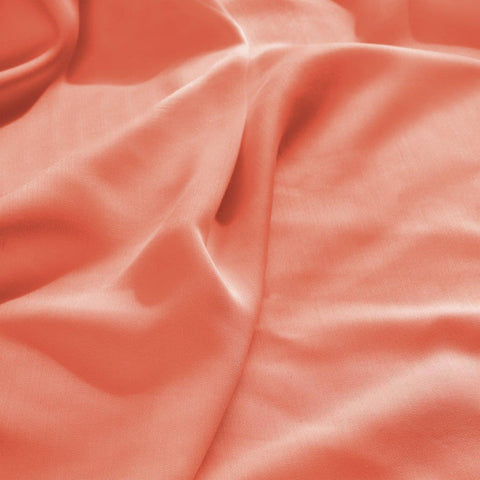 Soft coral Egyptian cotton bed sheet with luxurious texture and elegant drape