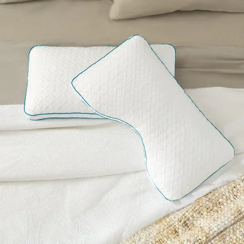 White quilted pillows with teal trim on luxury bedding, perfect for comfortable sleep