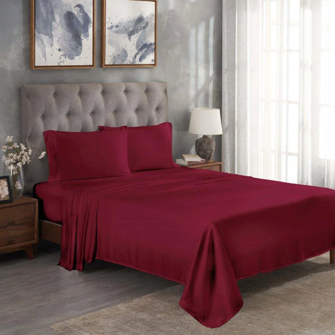 Luxury burgundy Egyptian cotton bed sheets with pillowcases on a tufted bed, modern bedroom decor