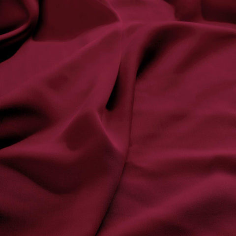 Luxury burgundy Egyptian cotton bedding with soft, elegant folds for premium comfort.