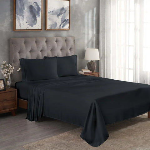 Luxury black Egyptian cotton bed sheets and pillowcases on a tufted bed in modern bedroom