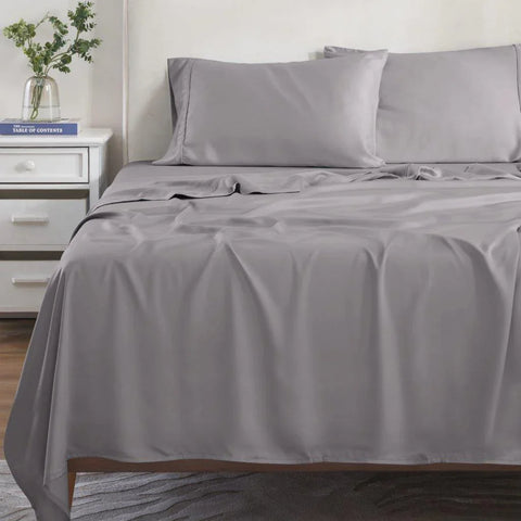Gray Egyptian cotton bed sheets and pillowcases on a made bed, luxury bedding set