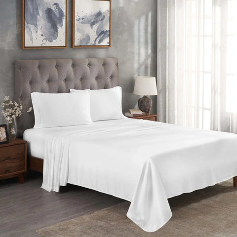 White Egyptian cotton bed sheets and pillowcases on a tufted bed in a modern bedroom