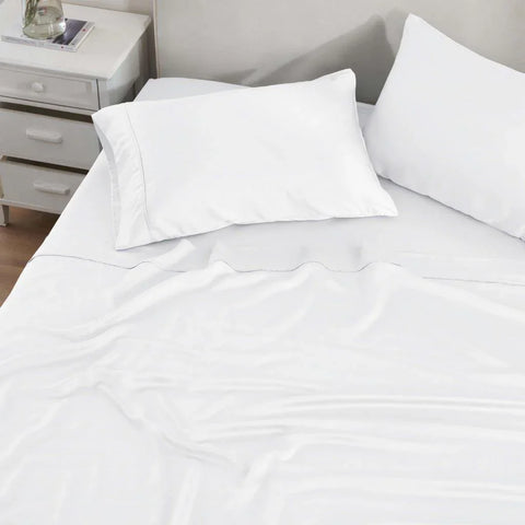 White Egyptian cotton sheet set with pillowcases on a neatly made bed, luxury bedding